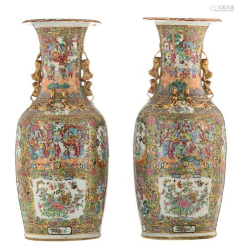 A pair of large Chinese Canton famille rose and relief decorated vases, the roundels with court scenes, birds, butterflies and flower branches, 19thC, H 81 - 82 cm