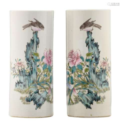 A pair of Chinese famille rose cylindrical vases, decorated with flower branches and a finch on a rock, H 28 cm