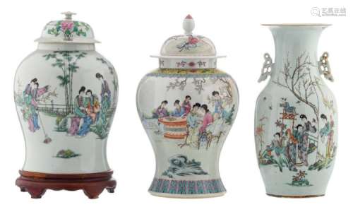 A Chinese famille rose vase and vase and cover, decorated with gallant garden scenes and calligraphic texts, one vase on a matching wooden base; added a ditto vase, marked, H 39,5 - 44,5 cm