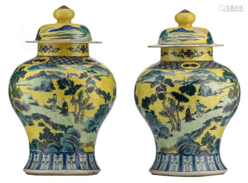A pair of Chinese yellow ground polychrome vases and covers, overall decorated with figures in a mountainous river landscape, about 1900, H 39,5 cm