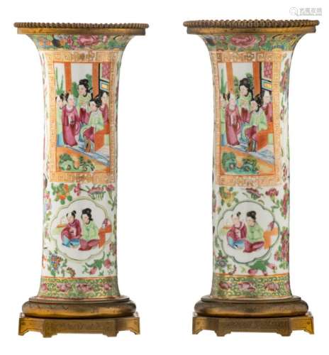 A pair of Chinese Canton famille rose floral decorated cylindrical vases, the roundels with court scenes, with gilt bronze mounts, about 1900, H 32,5 cm