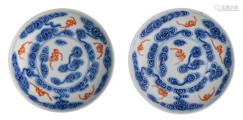 Two Chinese cobalt blue and iron red underglaze dishes, decorated with bats amid clouds, with a Qianlong mark, ø 14,5 cm