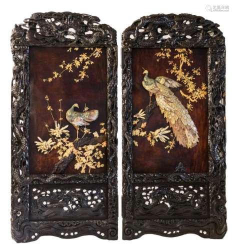 A two-fold Chinese screen with carved wooden frame, the panels with ivory and mother-of-pearl peacocks on a flower branch, 20thC, 94 x 102 cm (x2)