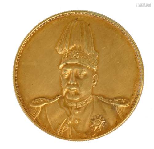 A Chinese commemorative 'golden' one dollar coin, depicting YuanShiKai, signed Giorgi