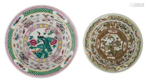 A Chinese famille rose bowl, decorated with antiquities, the medallion with a peacock on a rock and flower branches, 19thC; added a similar bowl, H 13 - 13,5 - ø 33,5 - 41 cm