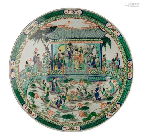 A large Chinese famille verte plate, decorated with an animated garden scene and auspicious symbols, the exterior rim with flower branches, H 13 - ø 65,5 cm