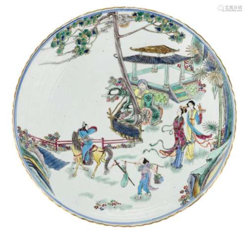 A Chinese polychrome plate, decorated with an animated scene in a palace garden, with a Kangxi mark, H 5 - ø 35,5 cm