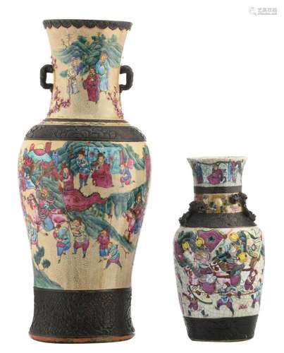 A Chinese famille rose stoneware baluster shaped vase, overall decorated with warriors in a landscape, marked, about 1900; added a ditto dragon relief decorated vase, H 35 - 61 cm