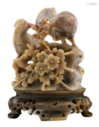 A Chinese carved soap stone sculpture, depicting flower branches and two birds on a rock, on a ditto base, H 13 cm