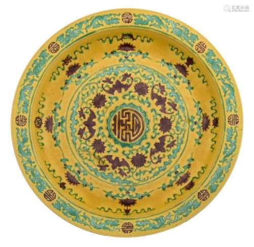 A Chinese sancai platter, decorated all over with shou characters, bats and scrolling lotus, the upright part with the eight Buddhist symbols, with a Yongzheng mark, H 7 - ø 41,5 cm