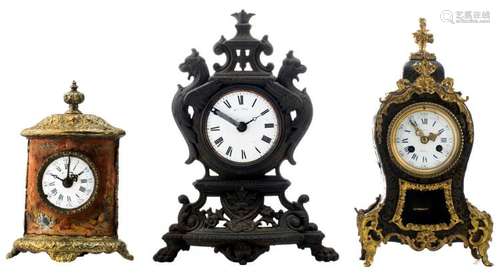 A Boulle table clock; added a polychrome painted bronze mounted tole table clock and a cast iron table clock, H 23 - 31 cm