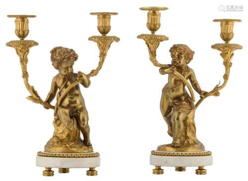 A pair of 20thC Neoclassical gilt bronze candelabras on a white marble base, H 35 - 37 cm