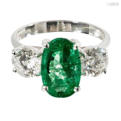 An emerald and diamond set three stone ring Ring size: L, estimated total gem weights: emerald 2.65cts, diamonds 1.41cts