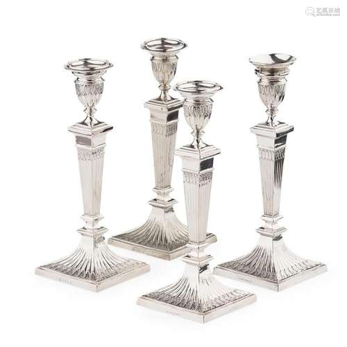 A set of four plated table candlesticks Height: 25cm