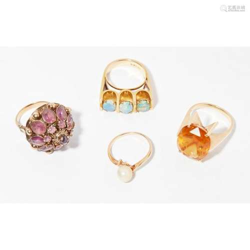 A collection of four gem set rings