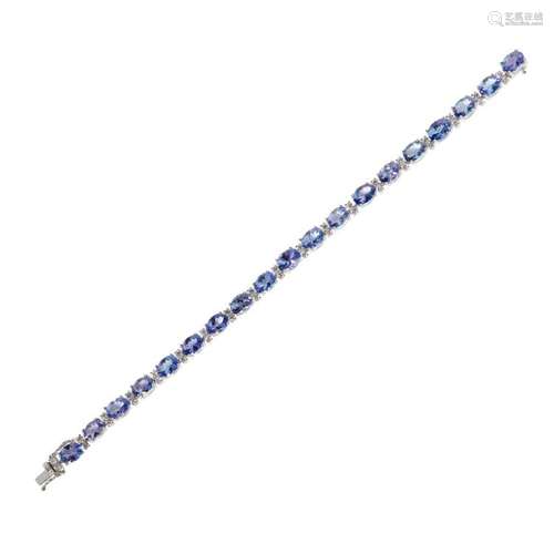 An 18ct gold Tanzanite and diamond set line bracelet Length: 18cm, estimated total gem weights: Tanzanites: 16.00cts, diamonds 1.25c...