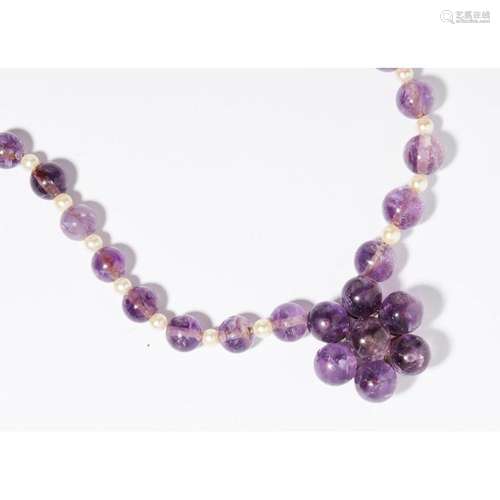 A 1940s amethyst and cultured pearl bead necklace Length of shortest strand: 56cm, amethyst beads: 12.7mm - 17mm