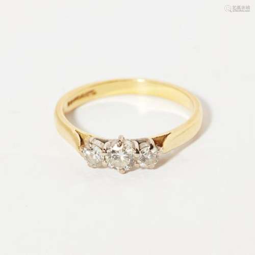 A three stone diamond ring Ring size: N