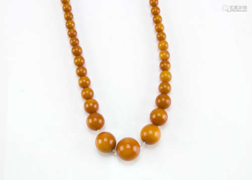 An Art Deco period amber style bead necklace