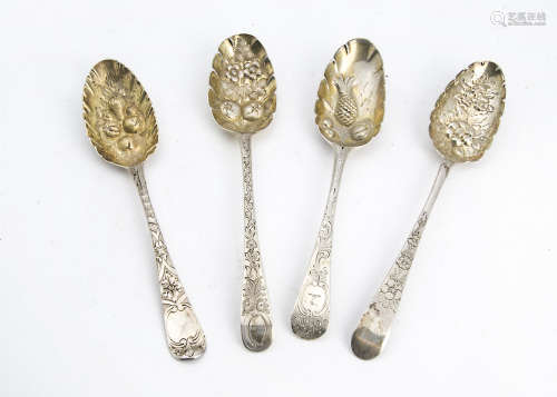 A group of four George III and later silver berry serving spoons