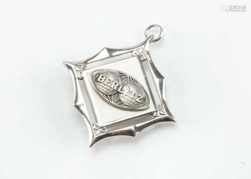 A c1970s sterling silver pendant cum pin badge in a Cartier fitted box