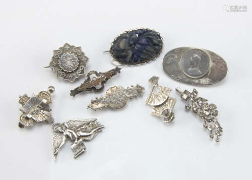 Eight Victorian and later silver and white metal brooches