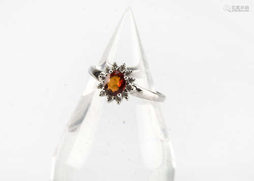 A modern 18ct white gold sunset sapphire and diamond cluster ring