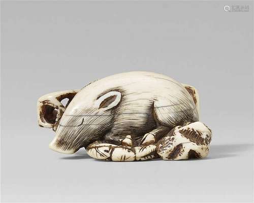 A good Kyoto school ivory netsuke of a recumbent boar on a bed of leaves. Late 18th century