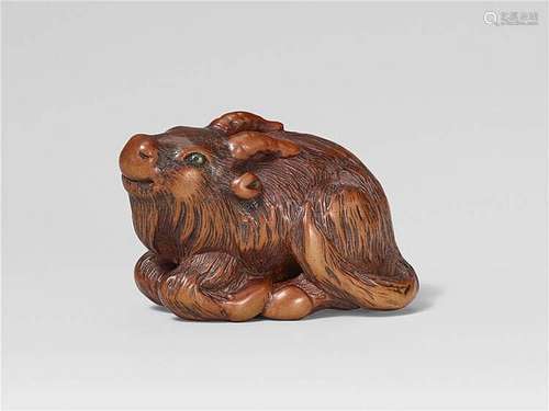 A good Tsu school boxwood netsuke of a recumbent goat. Early 19th century