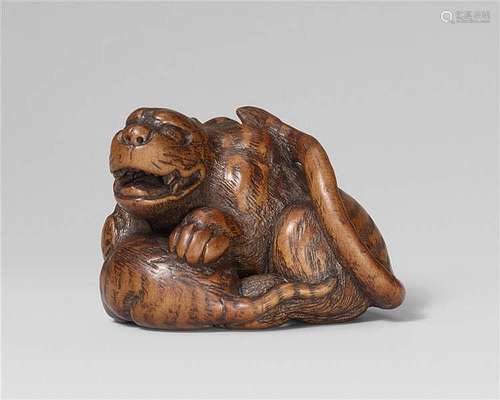 A fine Tsu school boxwood netsuke of a tiger with a cub. Early 19th century