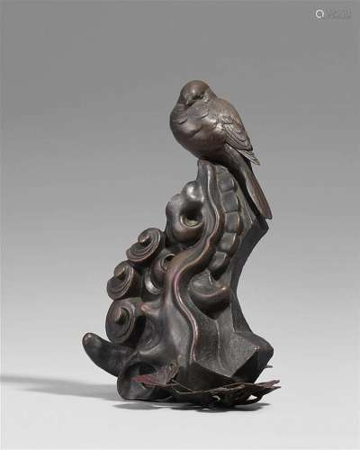 A bronze okimono of a bird perched on a rock. Around 1900
