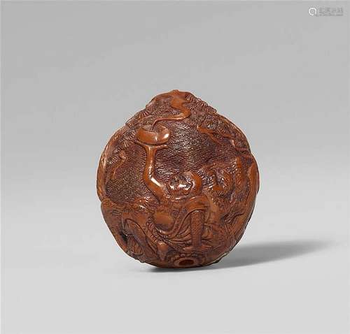 A finely carved walnut netsuke of rakan Handaka Sonja with a dragon, by Kozan. Mid-19th century