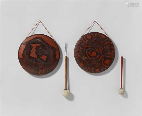 Two copper gongs, each with a striker. 19th/20th century