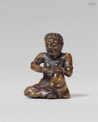 An unusual wood netsuke of Kugyô Shaka. Late 19th century