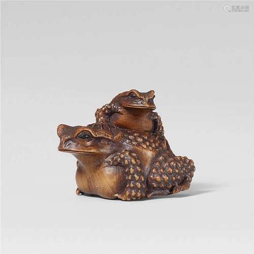 An Ise-Yamada school boxwood netsuke of two toads, by Masanao. Late 19th century