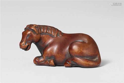 A very fine boxwood netsuke of a recumbent horse. Early 19th century