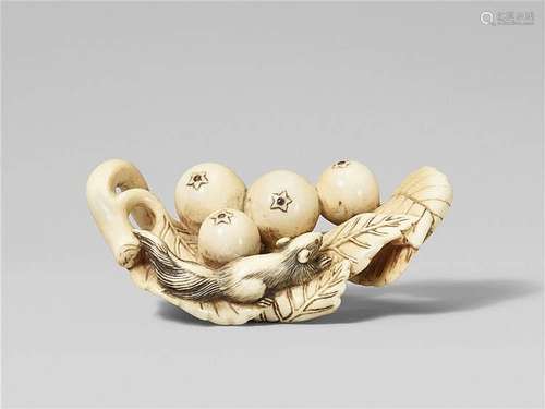 An ivory netsuke of a group of loquat and a squirrel. Early 19th century