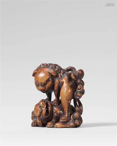 A rare large boxwood netsuke of two fighting shishi. Late 18th century