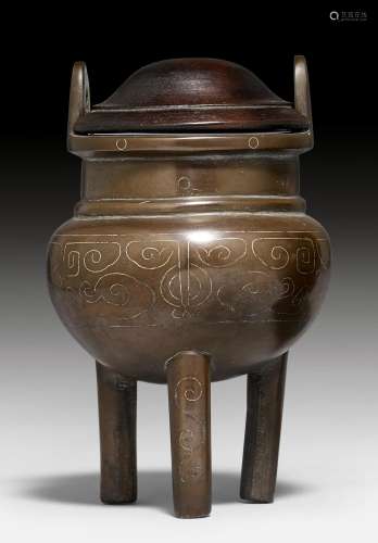 A BRONZE TRIPOD CENSER WITH SILVER INLAYS.