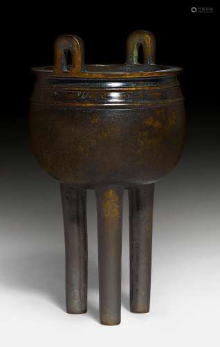 A BRONZE INCENSE BURNER ON THREE TALL LEGS.