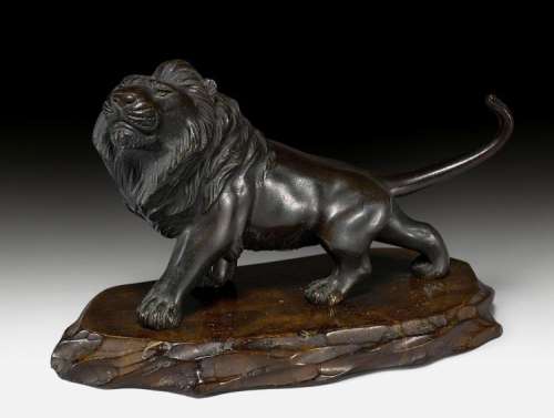 A SMALL BRONZE LION.