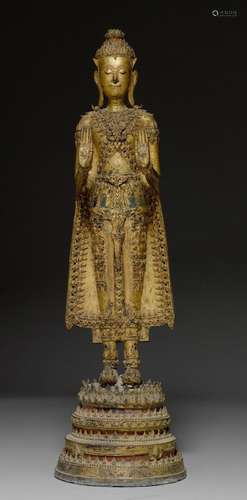 A LACQUER GILT BRONZE STANDING FIGURE OF BUDDHA.