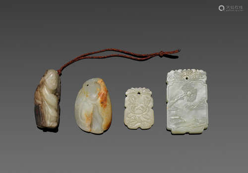 a group of Four jade carvings