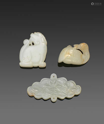 a group of Three jade carvings