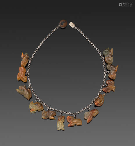 A silver link necklace mounted with twelve hardstone zodiac animals