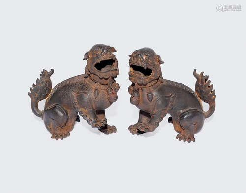 Qing dynasty A pair of cast iron lion-dog form incense burners