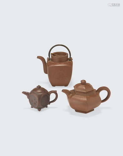 a group of Three Yixing pottery teapots