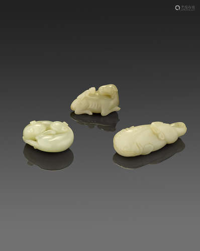 a group of Three zoomorphic jade carvings