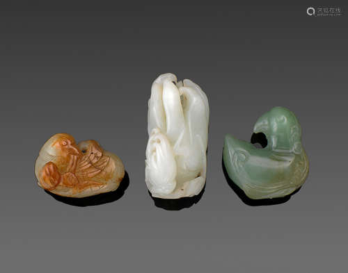 a group of Three small jade carvings