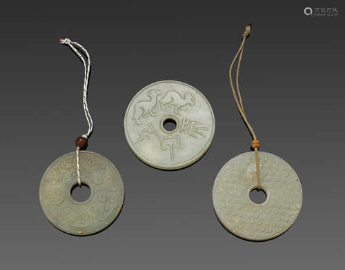 a group of Three jade disks